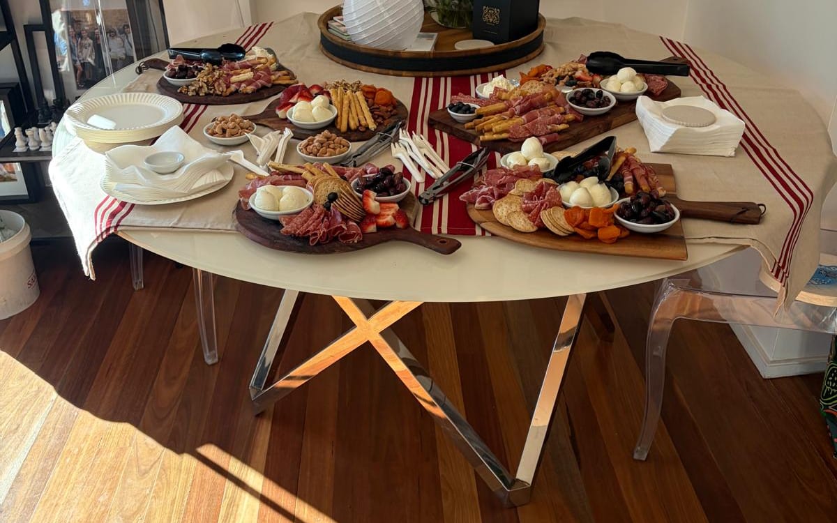 An antipasto spread of cured meats, olives, figs and soft cheeses laid out for a corporate event